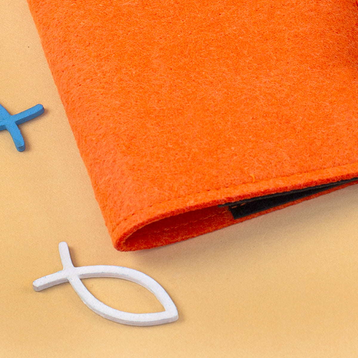 Detailaufnahme der orangefarbenen Filz-Buchhülle mit sichtbarer Materialstruktur und Naht