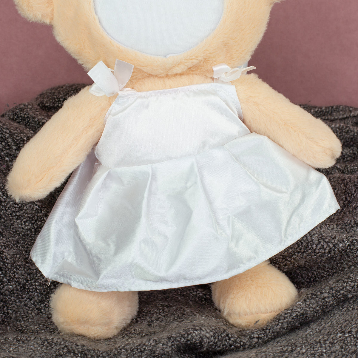 Detailaufnahme vom weißen Brautkleid am personalisierten Kuscheltier
