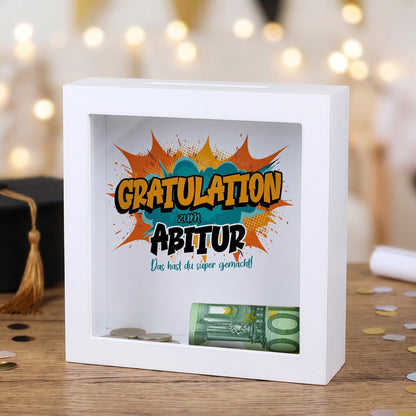 Weiße Bilderrahmen-Spardose als Geldgeschenk zum Abitur mit Comic-Motiv „Gratulation“