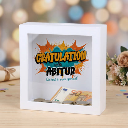 Weiße Bilderrahmen-Spardose als Geldgeschenk zum Abitur mit Comic-Motiv „Gratulation“
