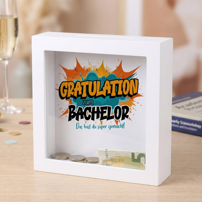 Bilderrahmen-Spardose „Gratulation zum Bachelor“ mit Geldschein und Münzen hinter Glas