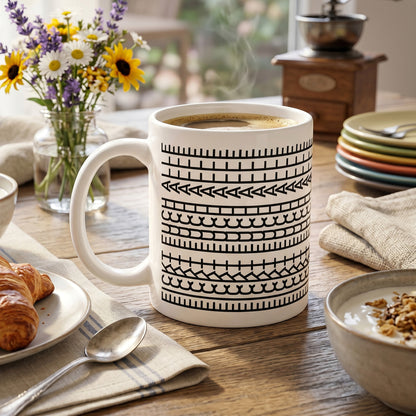 Weiße Keramiktasse mit versteckter Botschaft auf Frühstückstisch neben Blumen und Croissant