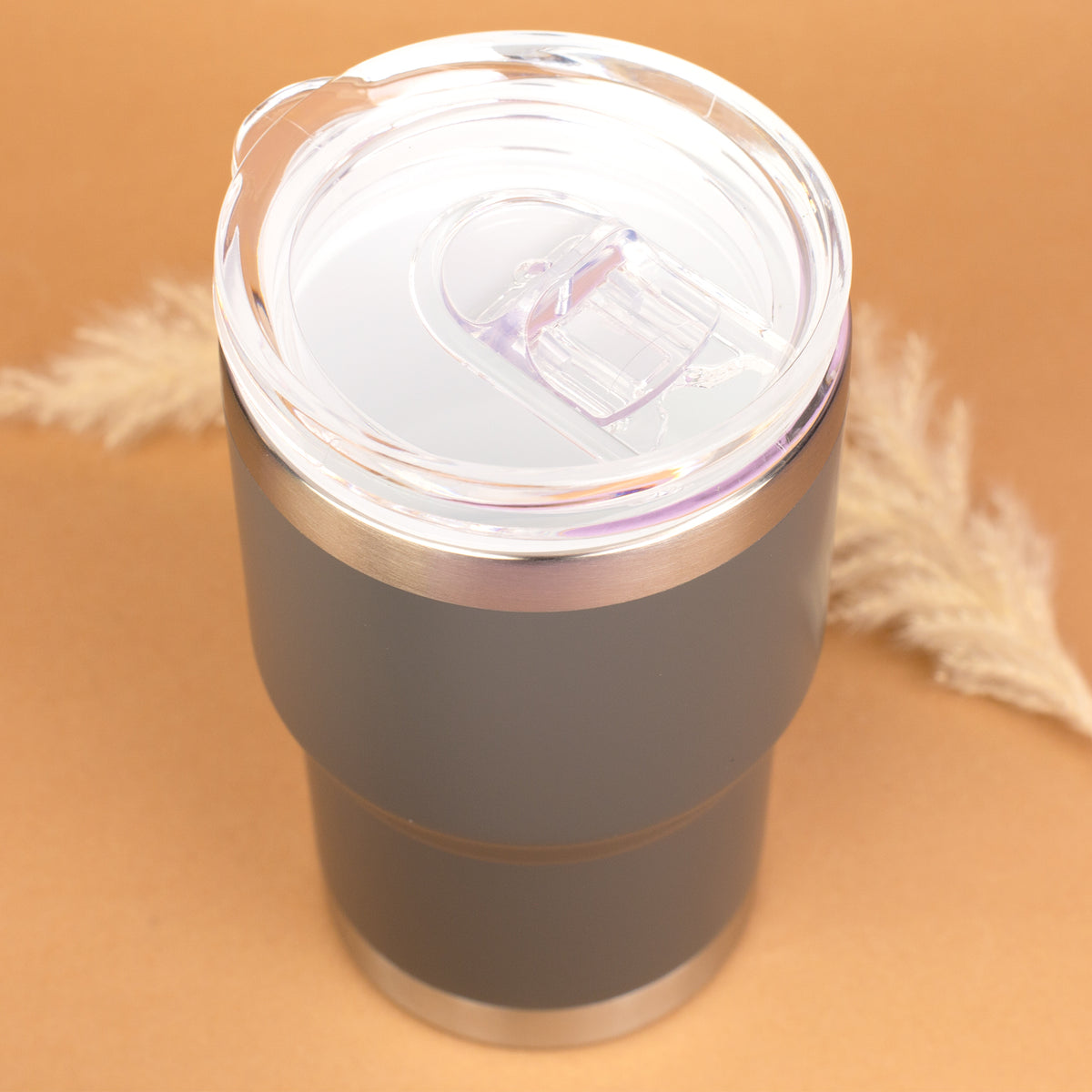Draufsicht auf grauen Thermobecher mit transparentem Deckel und Schiebetrinköffnung