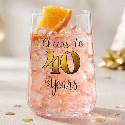 Trinkglas zum 40. Geburtstag mit Cheers to 40 Years Aufdruck, rosa Getränk, Eiswürfeln und Orangenscheibe