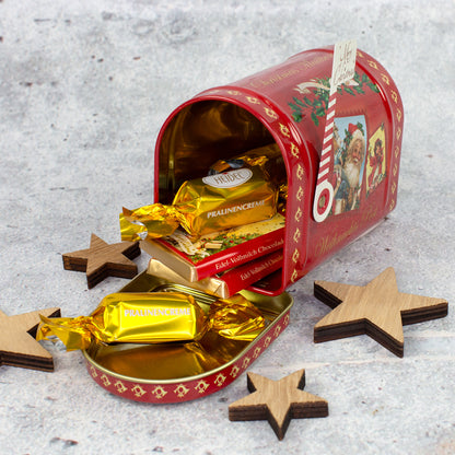 Geöffnete Heidel Weihnachts-Mailbox mit Pralinen und Vollmilchschokolade