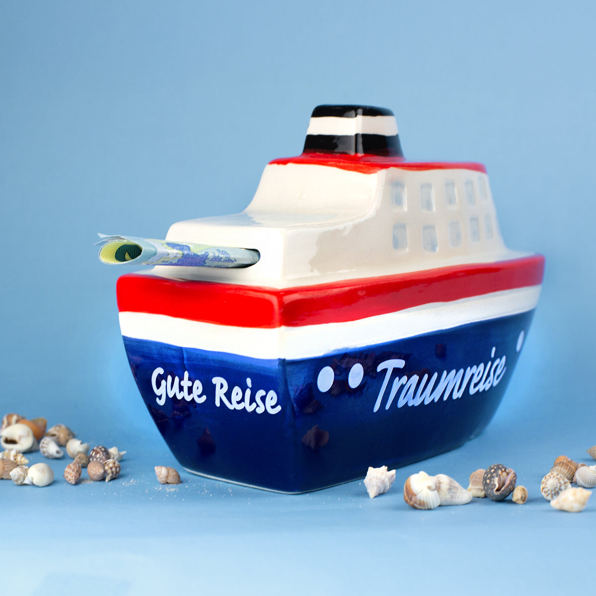 Rückseite der Schiff Spardose mit Aufschrift Gute Reise Traumreise und Geldschein