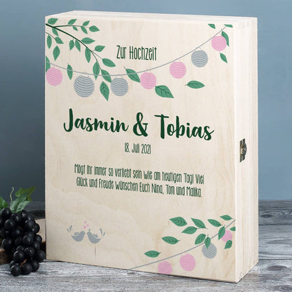 Gravierte Weingläser mit Weißwein in festlicher Holzverpackung zur Hochzeit