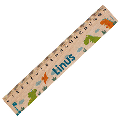 Freigestelltes personalisiertes Holzlineal mit Dinosauriern und Name Linus