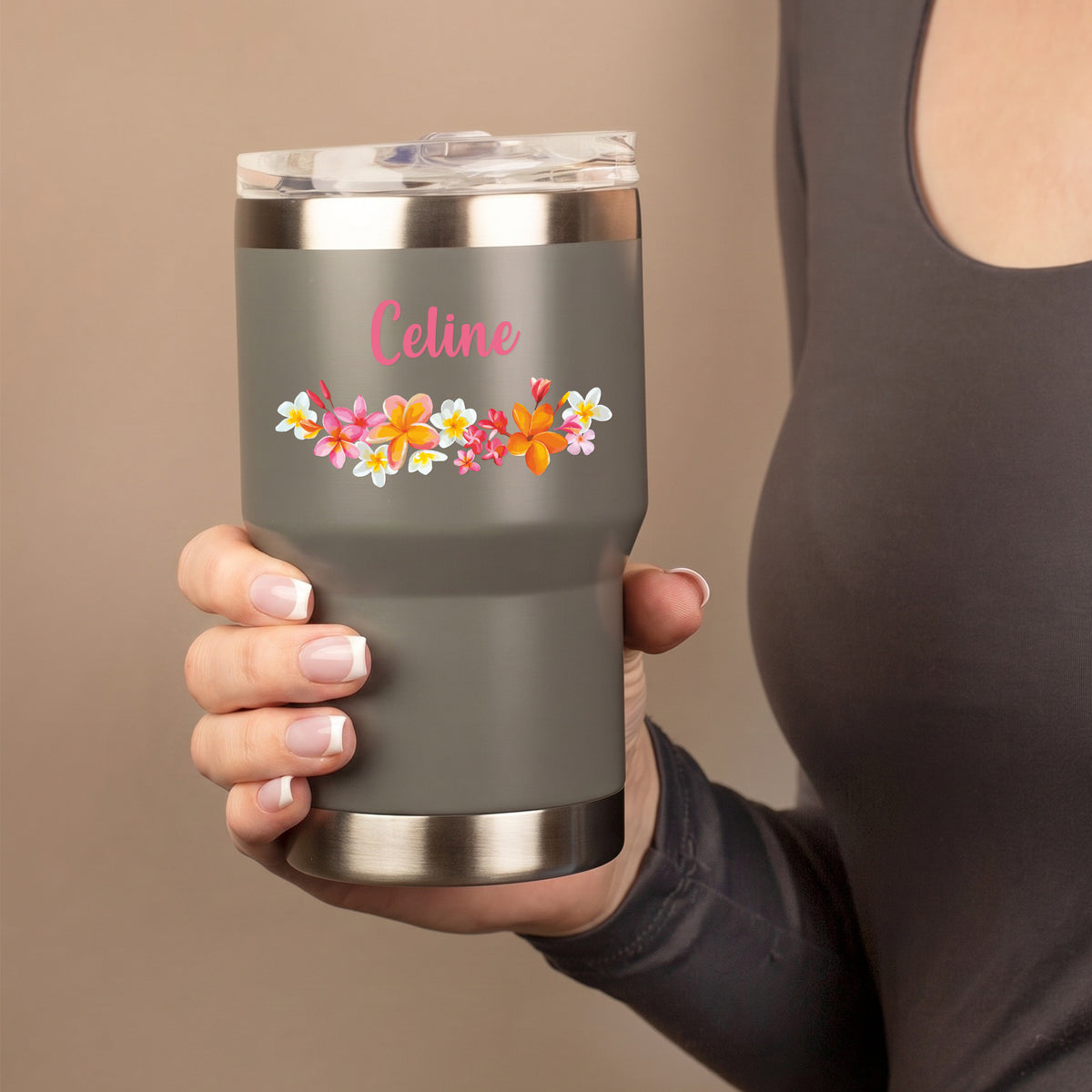 Grauer Thermobecher mit Blumenmotiv und Name Celine wird von einer Person in der Hand gehalten