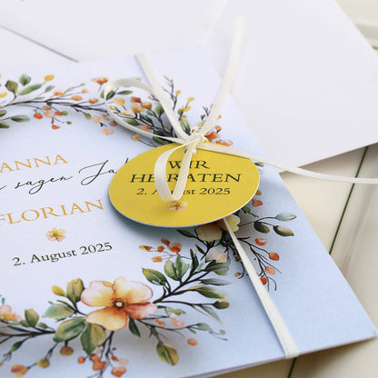 Einladungskarte zur Hochzeit mit Blütenkranz und rundem Anhänger