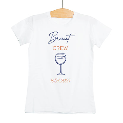 Weißes T-Shirt mit der Aufschrift „Braut Crew“ in Blau und Orange, Motiv: Weinglas mit Datum 16.09.2025 – ideal für den JGA.