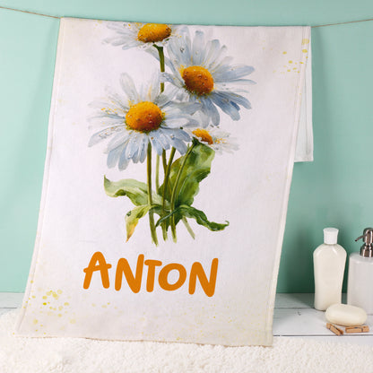 Weißes Handtuch mit Margeriten-Geburtsblume und Name Anton im Badezimmer