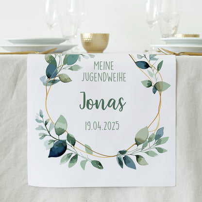 Tischläufer zur Jugendweihe mit Eukalyptus-Motiv, personalisiert mit Name Jonas und Datum, auf heller Tischdecke arrangiert