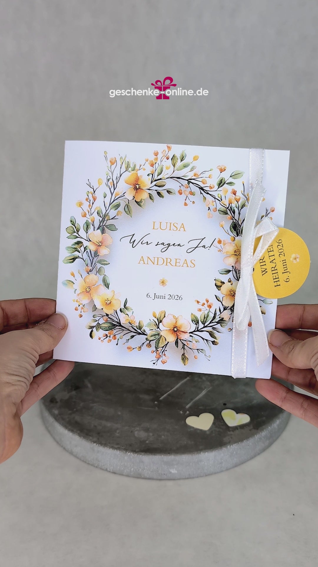 Hochzeitseinladung – Klappkarte mit gelbem Blumenkranz und Anhänger