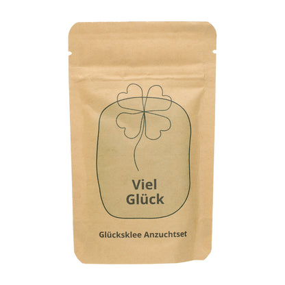 Freigestelltes Viel Glück Anzuchtset in Kraftpapiertüte mit Kleeblatt-Motiv